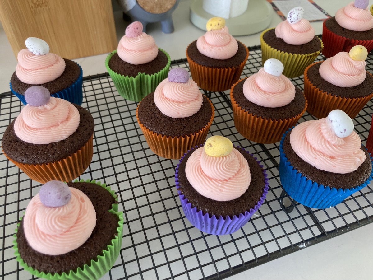Pink strawberry glazed cake topped with strawberries and sprinkles
